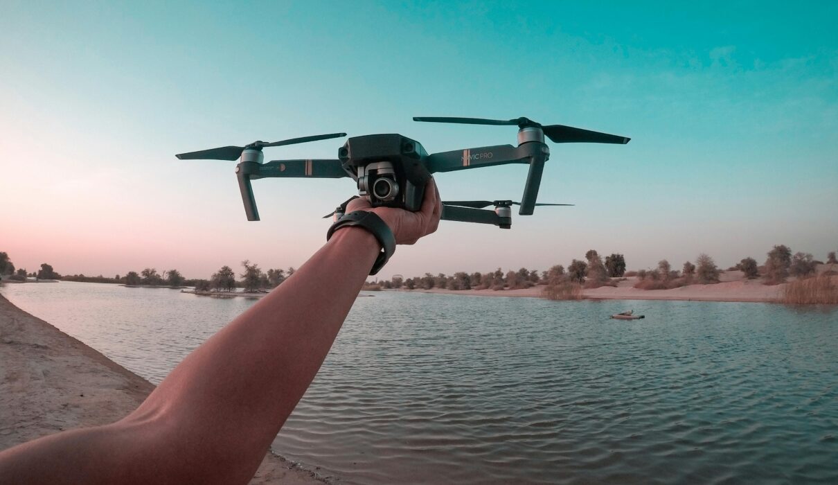 best budget drone flying over lake during sunset