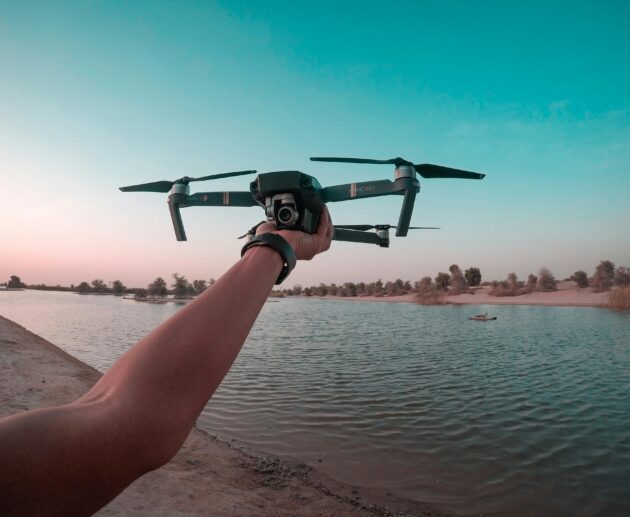 best budget drone flying over lake during sunset