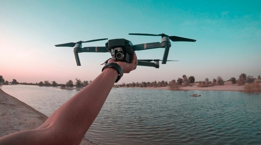 best budget drone flying over lake during sunset